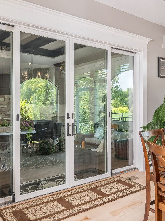 Sunroom Remodel with French Doors by Mankin Construction | Kansas & Missouri Renovation Specialists Remodeled sunroom with sliding French doors by Mankin Construction – home remodeling experts serving Kansas and Missouri